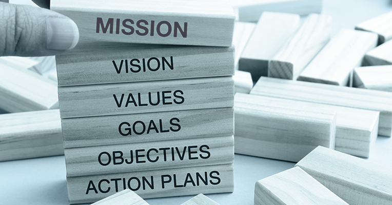Building Blocks with the words Mission, vision, value, goals, objectives and action plans written on them.