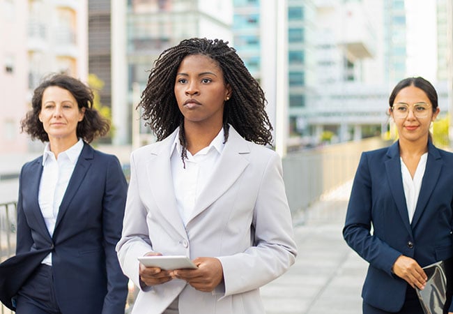 Strong female leader walking ahead of her team