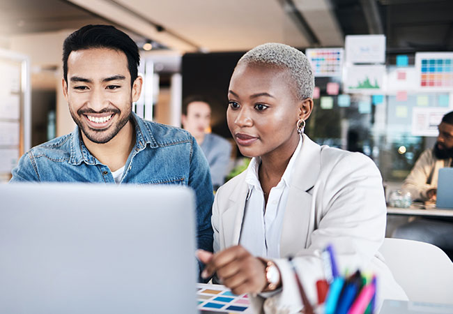 Two engaged workers helping each other