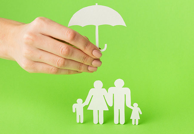Cardboard Family under a paper umbrella
