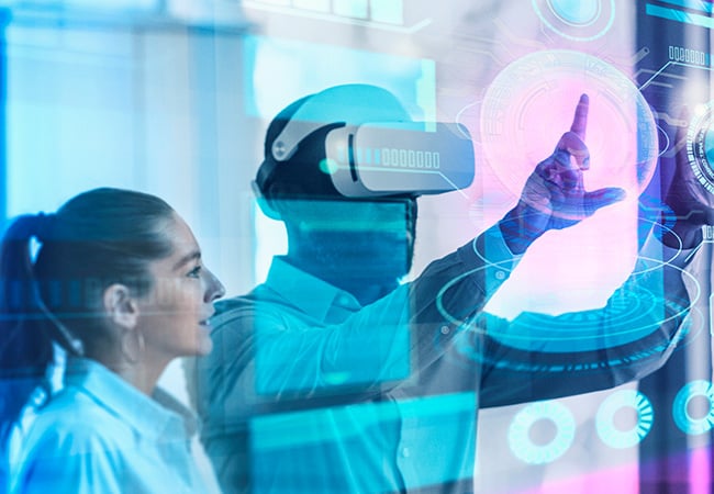 Man looking at statistics with a VR headset with their female manager next to him.