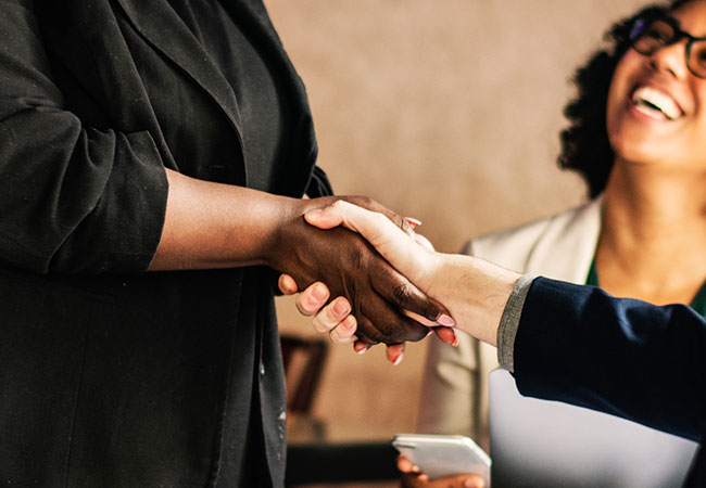 Happy customers shaking hands with service providers