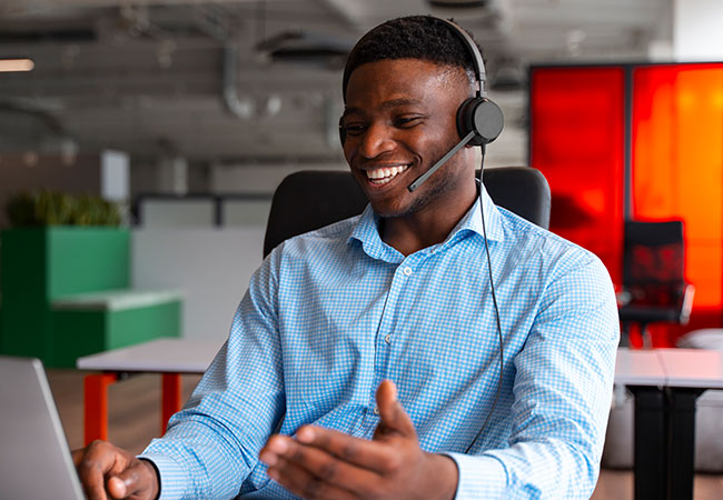 Happy customer care staff on the line with a client